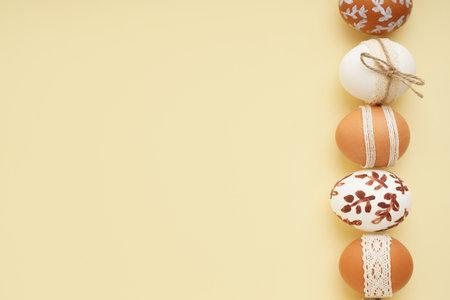 Composition with decorated Easter eggs on beige backgroundの写真素材