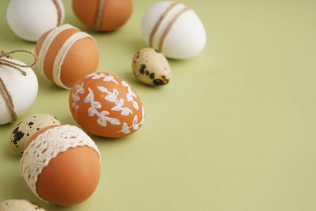 Decorated Easter eggs on green background