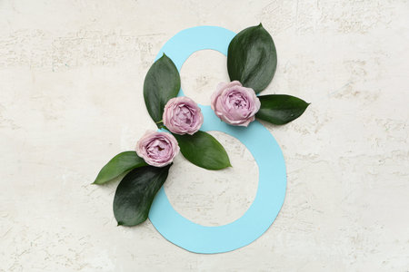 Figure 8 made of paper with beautiful roses and leaves on white background. International Women's...