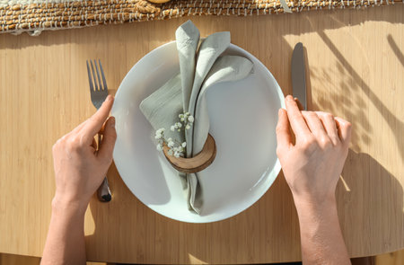 Female hands on wooden table served for International Women's Day celebration, closeupの写真素材
