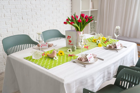 Dining table with bouquet of beautiful tulips served for International Women's Day celebration