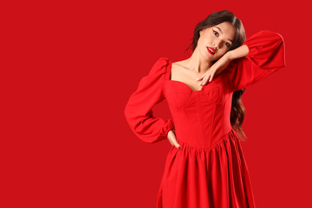 Beautiful young Asian woman in stylish elegant outfit on red backgroundの写真素材