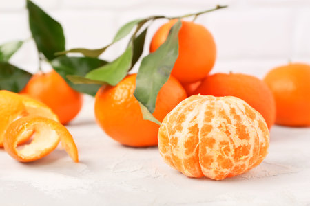 Tasty tangerines with leaves on white tableの写真素材