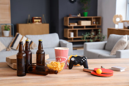Beer with snacks and activities on table at party, closeupの写真素材