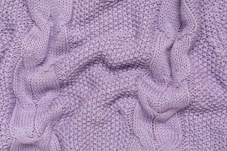 Texture of stylish knitted fabric with folds as background