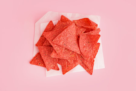 Red nachos on pink background