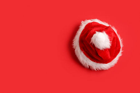 Santa Claus hat on red backgroundの写真素材