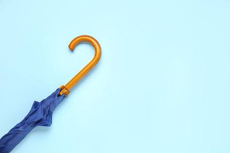Blue stylish umbrella on color backgroundの写真素材