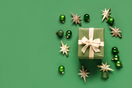 Gift box and Christmas balls on green backgroundの写真素材