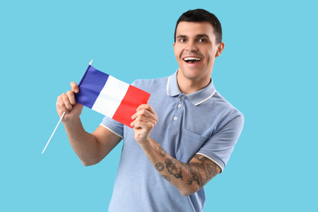 Young man with flag of France on blue backgroundの写真素材