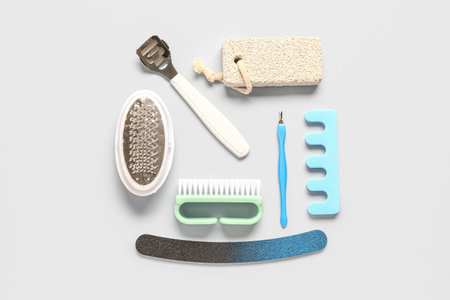 Set of professional supplies for pedicure on gray background