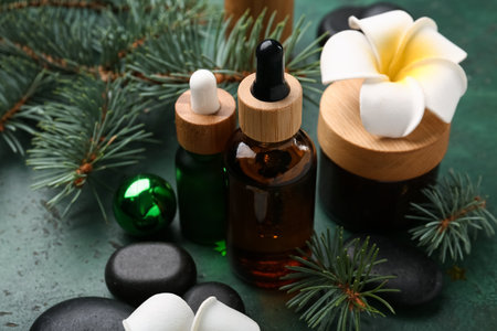 Composition with cosmetic products, spa stones and fir branches on color backgroundの写真素材