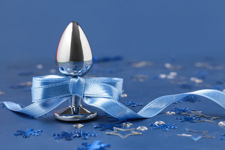 Anal plug with bow and snowflakes on blue background, closeupの写真素材