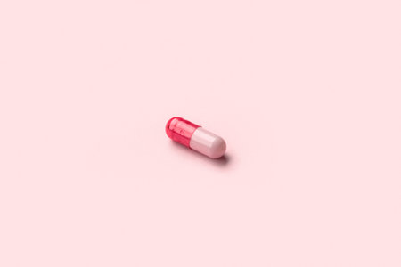 Medical capsule on pink backgroundの写真素材