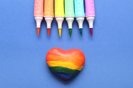 Rainbow heart with felt-tip pens on blue background. LGBTQ conceptの写真素材
