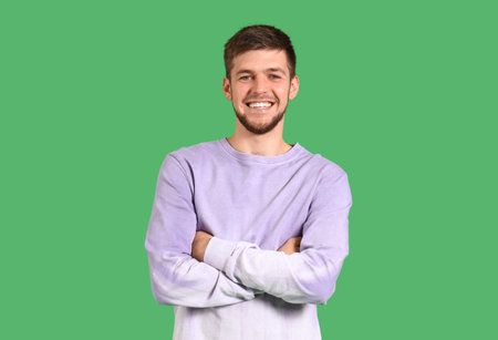 Young bearded man on green background