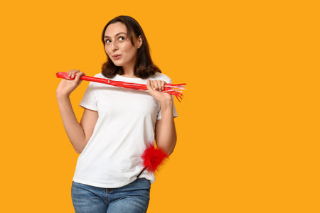 Dreaming young woman with different sex toys on yellow backgroundの写真素材