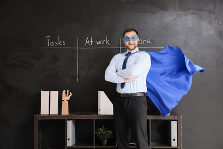 Business man dressed as superhero in officeの写真素材