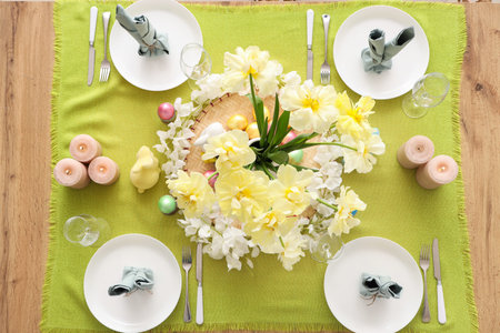 Festive table setting with spring flowers, napkins and candles