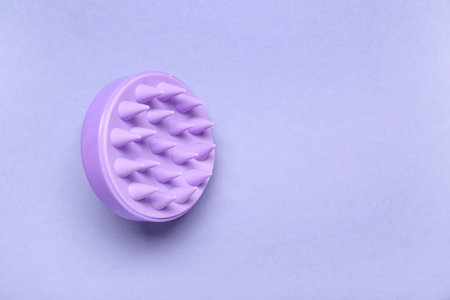Hair scalp massager on purple backgroundの写真素材