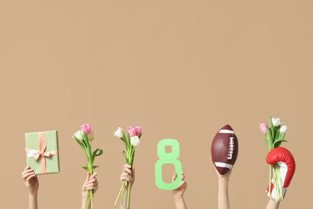 Female hands with sports equipment, gift box and tulip flowers for International Women's Day on color backgroundの写真素材