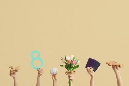 Female hands with paper figure 8, wooden toys, documents and flowers for International Women's Day on color backgroundの写真素材