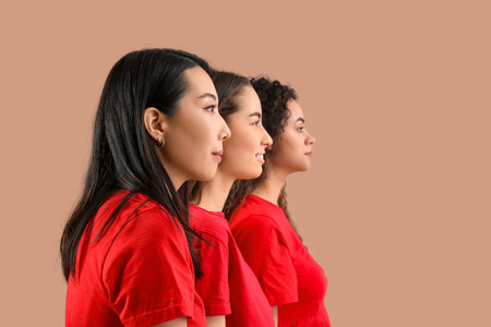 Beautiful young women on beige background. Women history monthの写真素材