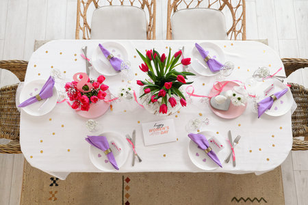 Dining table with beautiful flowers served for International Women's Day celebration