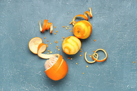 Composition with fresh oranges and peel on color background