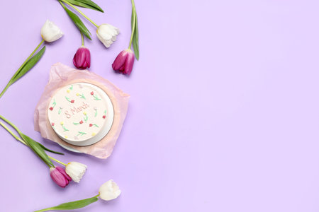 Sweet bento cake and beautiful tulips on lilac background. International Women's Day
