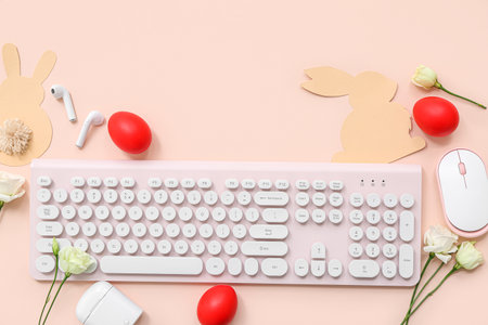 Easter eggs, mouse, flowers and computer keyboard on pink backgroundの写真素材