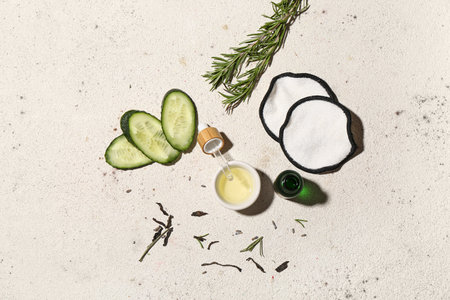 Composition with essential oil, natural ingredients and cotton pads on light backgroundの写真素材
