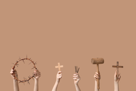 Female hands with crown of thorns, crosses, nails and mallet on color background. Good Friday conceptの写真素材
