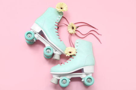 Composition with roller skates and flowers on pink background. International Women's Dayの写真素材