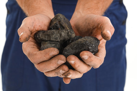 Mature miner man with coal on white background, closeupの写真素材