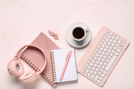 Computer keyboard, headphones, notebook and cup of coffee on white background