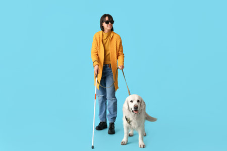 Blind woman with guide dog on blue backgroundの写真素材