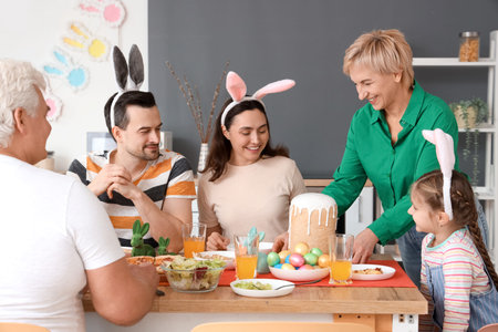 Mature woman bringing Easter cake for dinner with her family in kitchen
