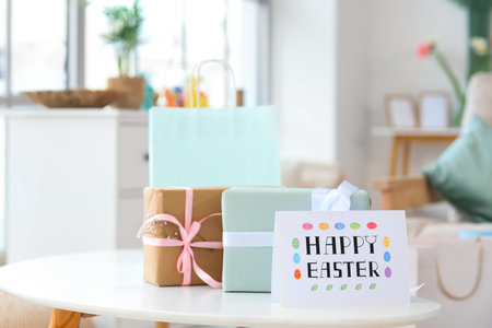 Shopping bag with gift boxes and festive postcard for Easter on table at homeの写真素材