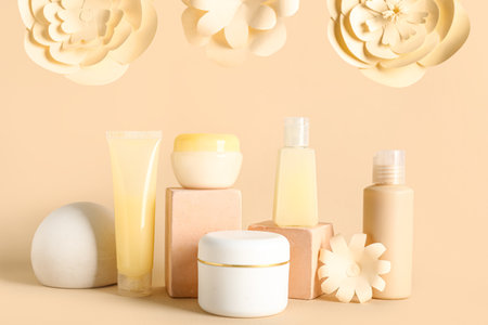 Facial cosmetic products composition with paper flowers on beige backgroundの写真素材