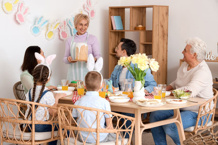 Mature woman bringing Easter cake for dinner with her family at home
