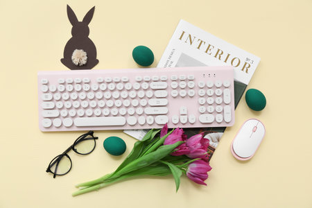 Easter eggs, magazine, tulips, glasses, computer keyboard and mouse on yellow background