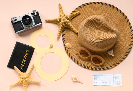 Composition with paper figure 8, beach accessories, photo camera and starfishes on color background. International Women's Dayの写真素材