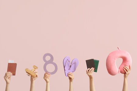 Female hands with documents, paper figure 8, flip-flops and travel pillow on color background. International Women's Dayの写真素材