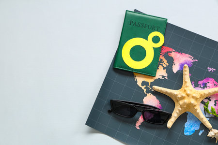 Composition with world map, passport, sunglasses and starfish on gray background. International...