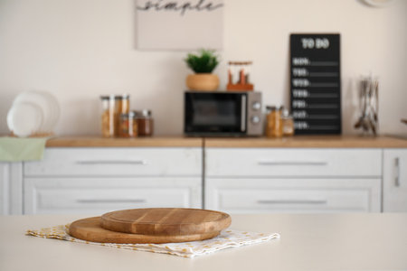Wooden cutting boards on table in modern kitchenの写真素材
