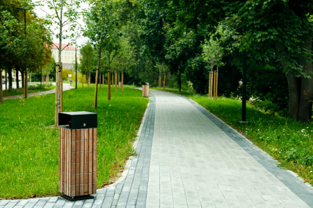 View of park with alley and garbage bin