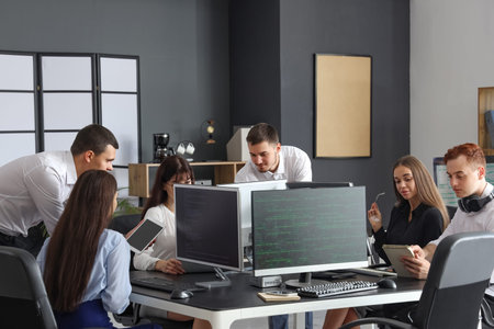 Team of young programmers working in office