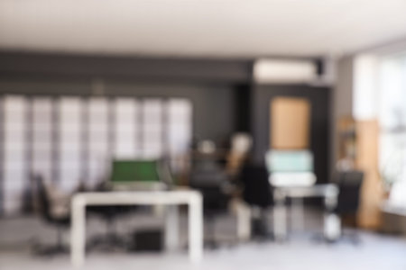 Blurred view of modern office with desks