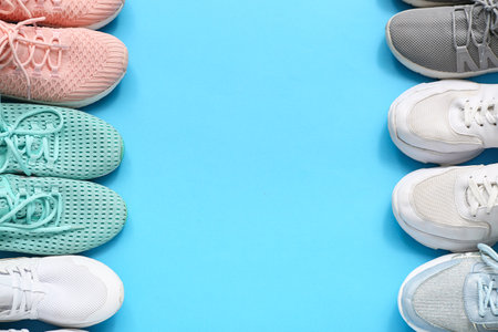 Different stylish sneakers on blue backgroundの写真素材